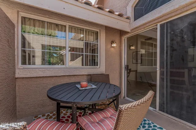 a backyard of a house with table and chairs