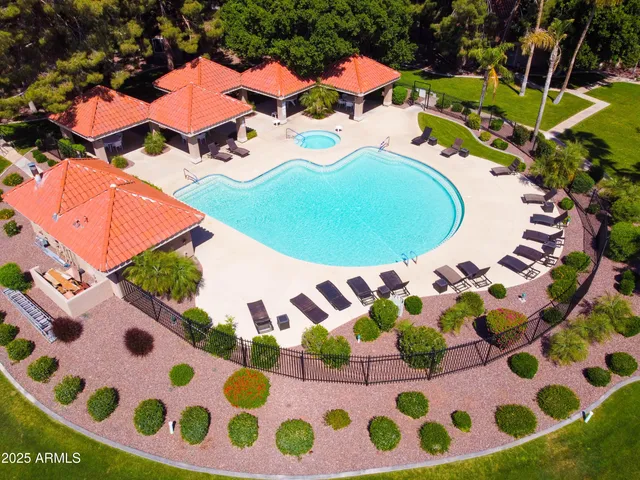 a view of a patio with a table and chairs under an umbrella