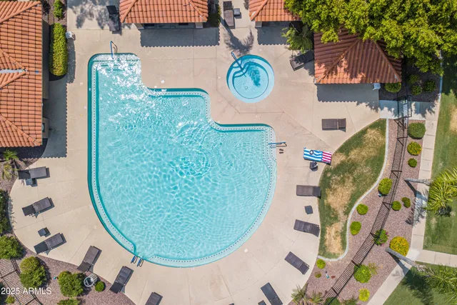 a front view of a house with a yard and palm trees