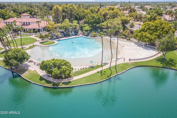 a view of a patio with table and chairs under an umbrella with a fire pit
