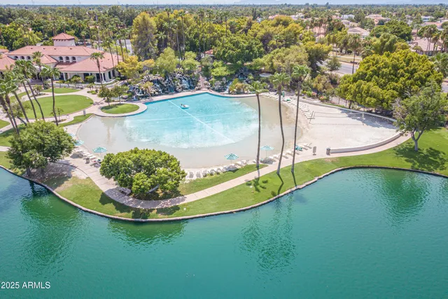 a view of a patio with table and chairs under an umbrella with a fire pit