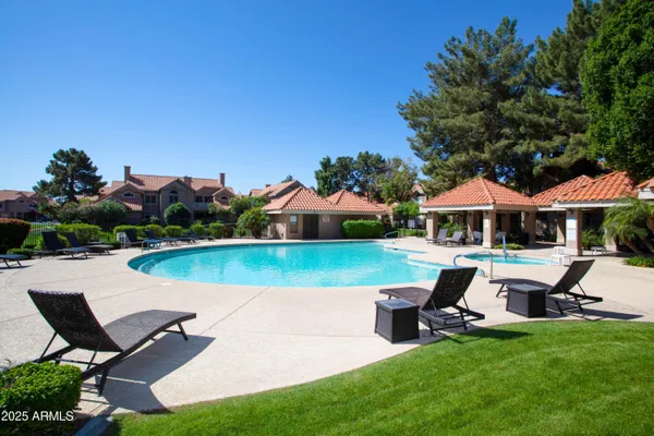 a swimming pool with some trees in the background