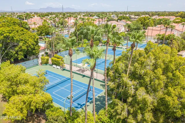 a view of a patio with a dining table and chairs under an umbrella