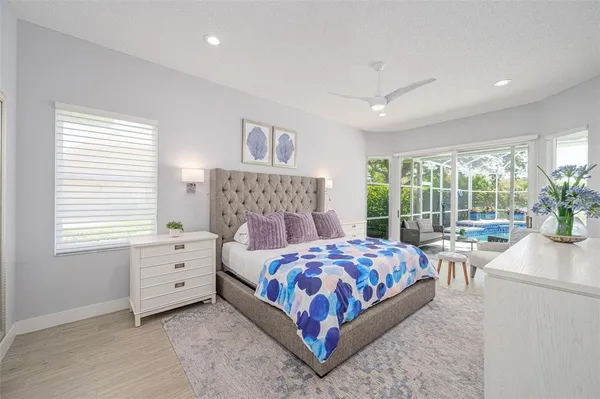 a bedroom with a large bed and a potted plant