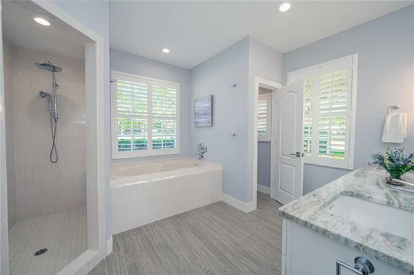 a bedroom with a bed and windows