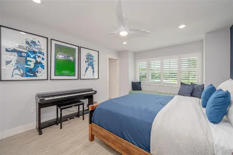 a bathroom with a granite countertop sink a toilet and a mirror