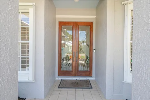 a dining room with furniture potted plants and wooden floor