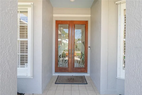 a dining room with furniture potted plants and wooden floor