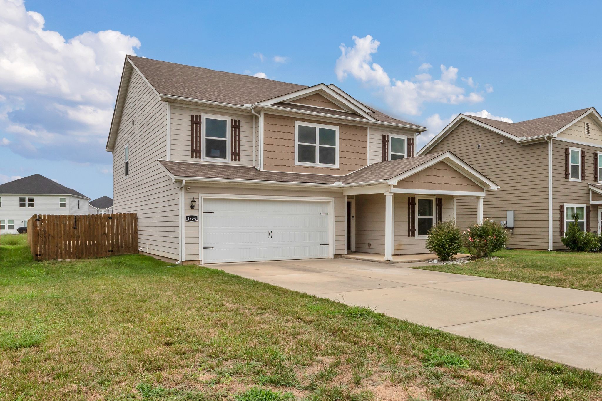 3734 Spahn Lane Murfreesboro, TN 37128 - Photo 23 of 25 a front view of a house with a yard and garage