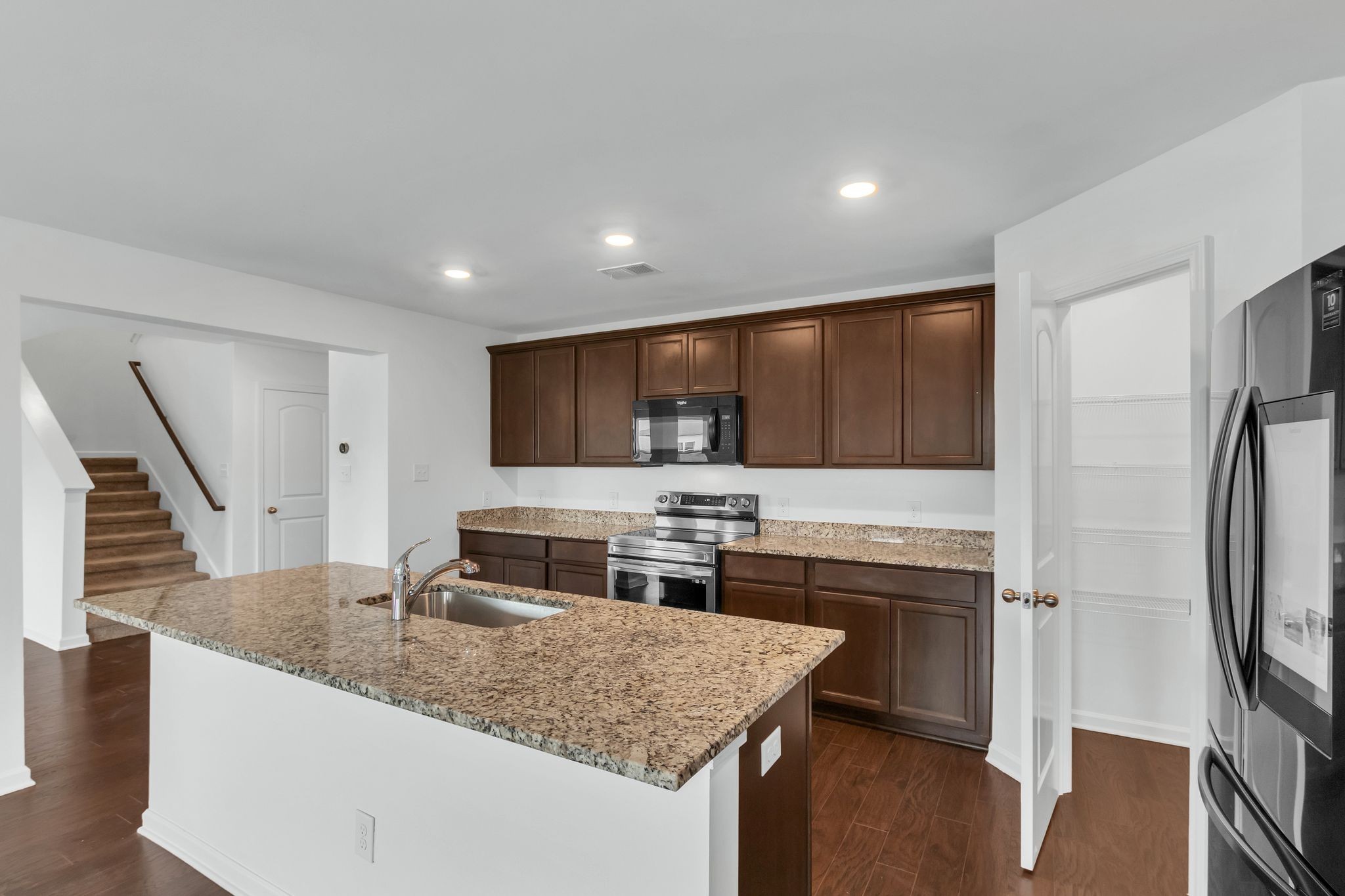 3734 Spahn Lane Murfreesboro, TN 37128 - Photo 8 of 25 a kitchen with stainless steel appliances granite countertop a sink stove and refrigerator
