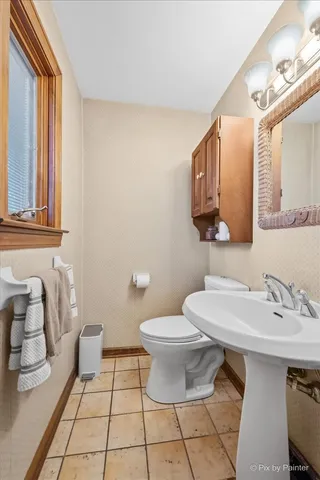 a bathroom with a sink toilet and mirror