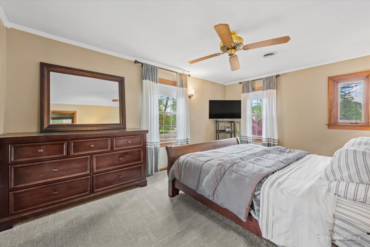 335 Arlington Road Itasca, IL 60143 - Photo 19 of 36 a bedroom with a bed and a chandelier