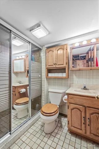a bathroom with a toilet a sink and a shower