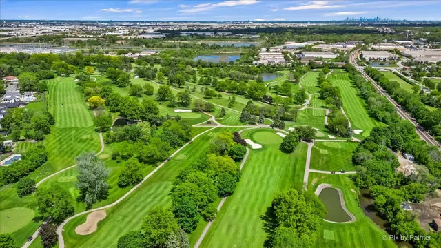 an aerial view of a golf course with a forest
