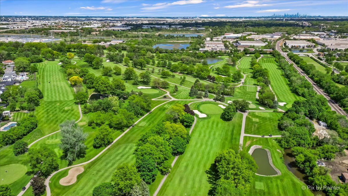 335 Arlington Road Itasca, IL 60143 - Photo 32 of 36 an aerial view of a golf course with a forest