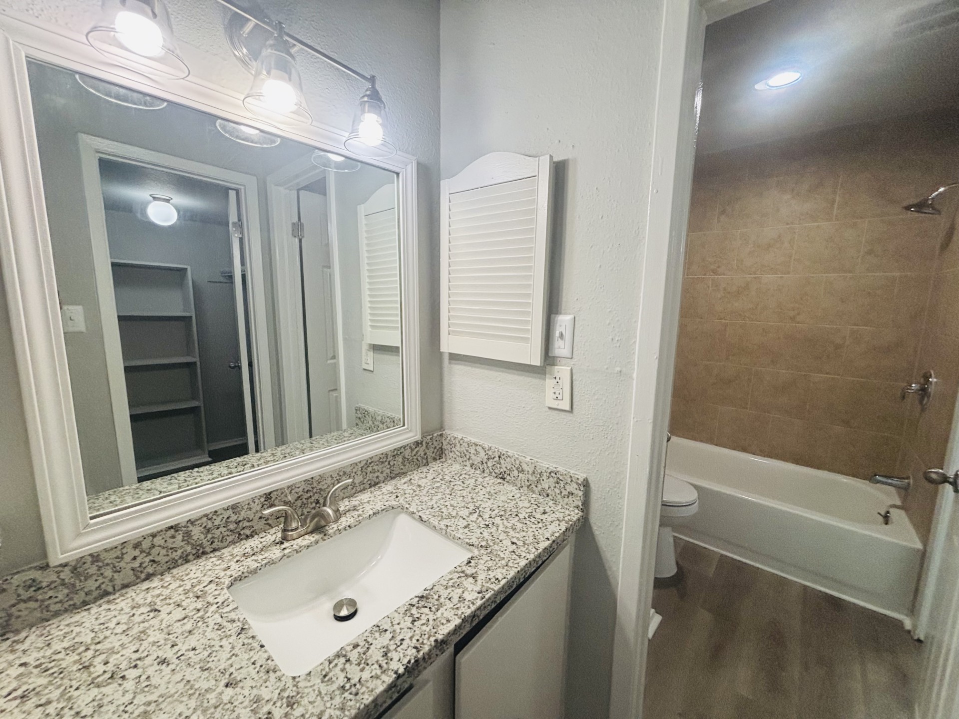 6200 West Tidwell Road, Unit 1109 Houston, TX 77092 - Photo 20 of 20 a bathroom with a granite countertop sink and a mirror
