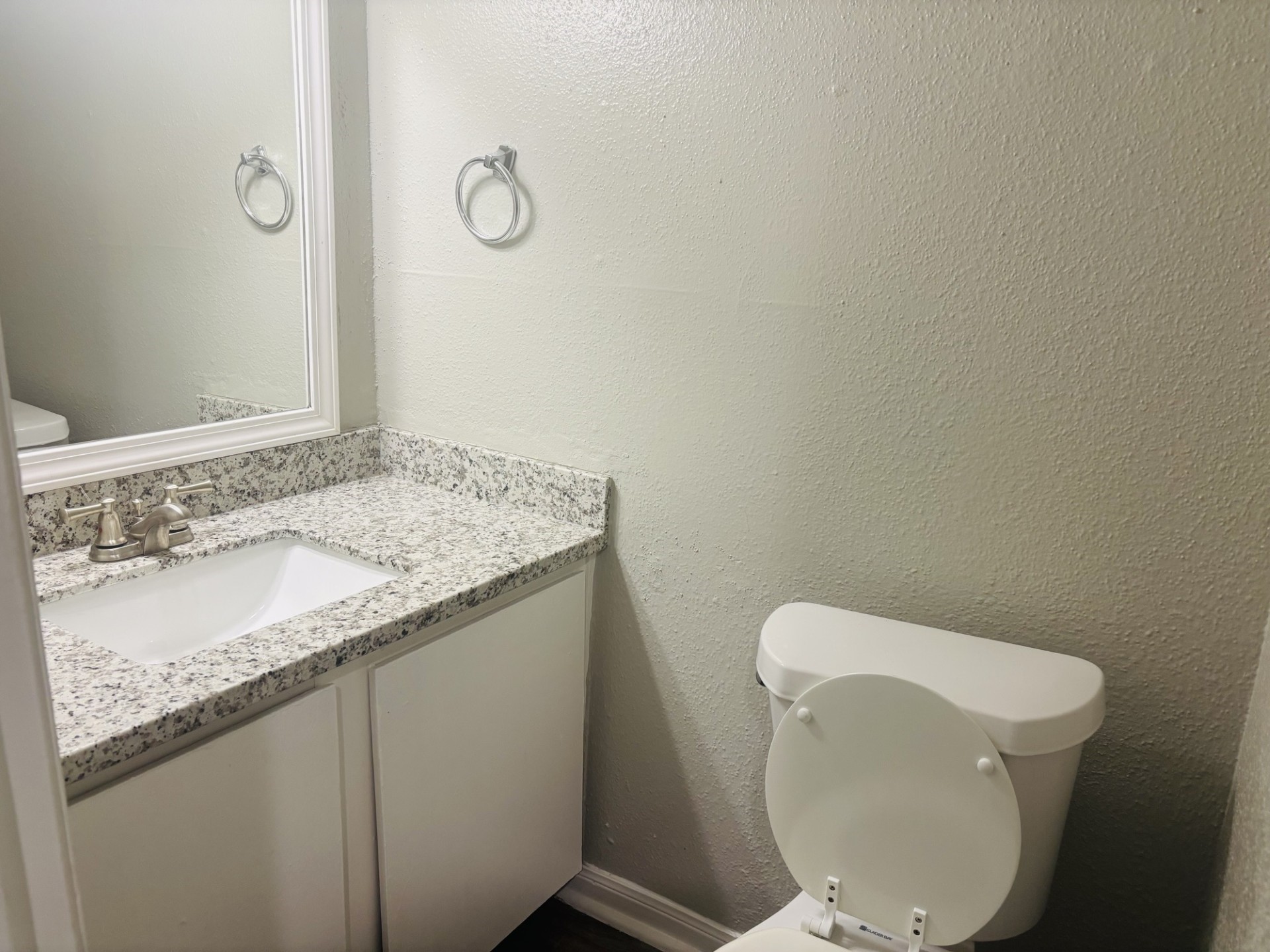 6200 West Tidwell Road, Unit 1109 Houston, TX 77092 - Photo 6 of 20 a bathroom with a granite countertop toilet and a sink