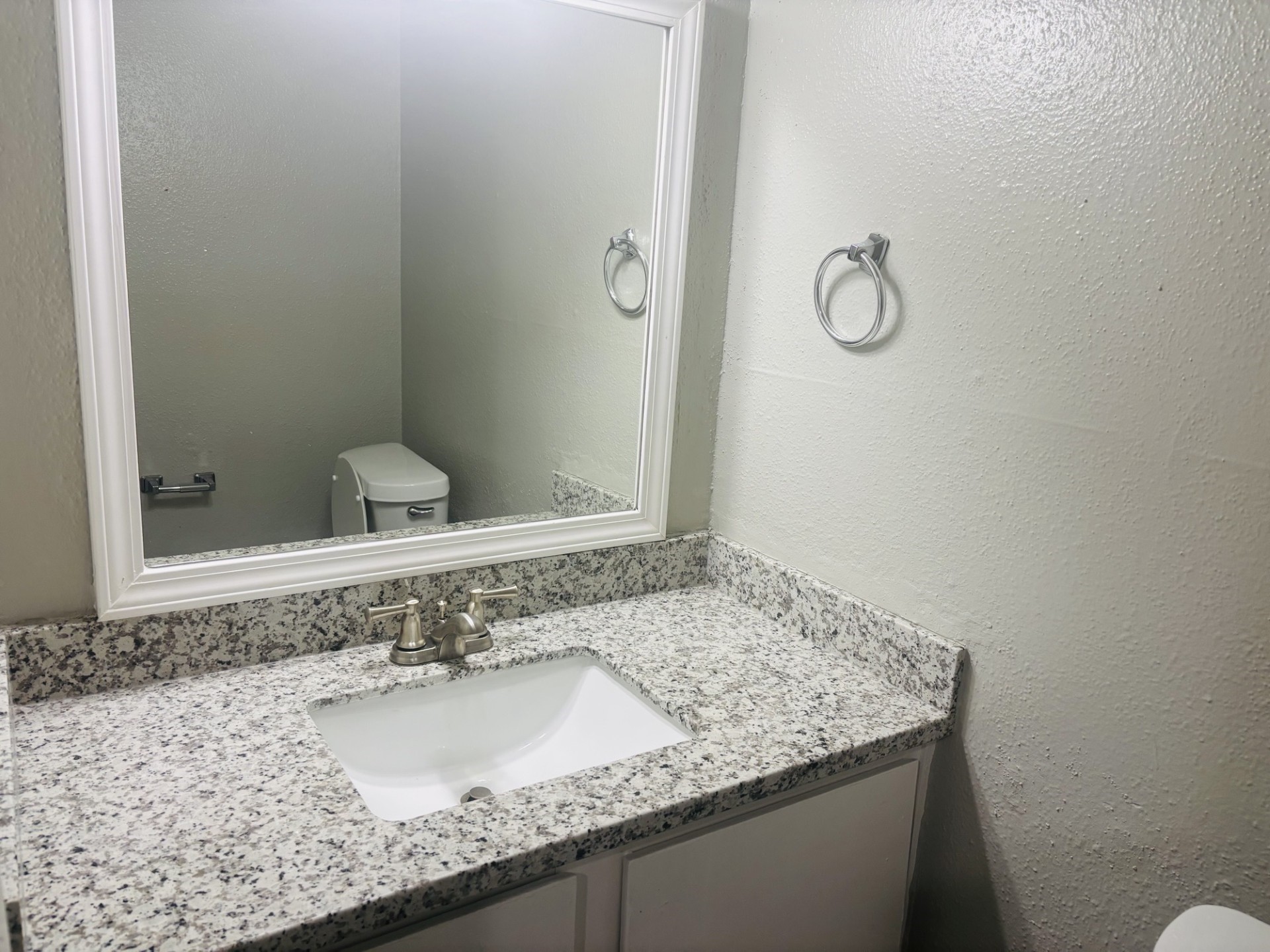 6200 West Tidwell Road, Unit 1109 Houston, TX 77092 - Photo 7 of 20 a bathroom with a granite countertop sink and a mirror