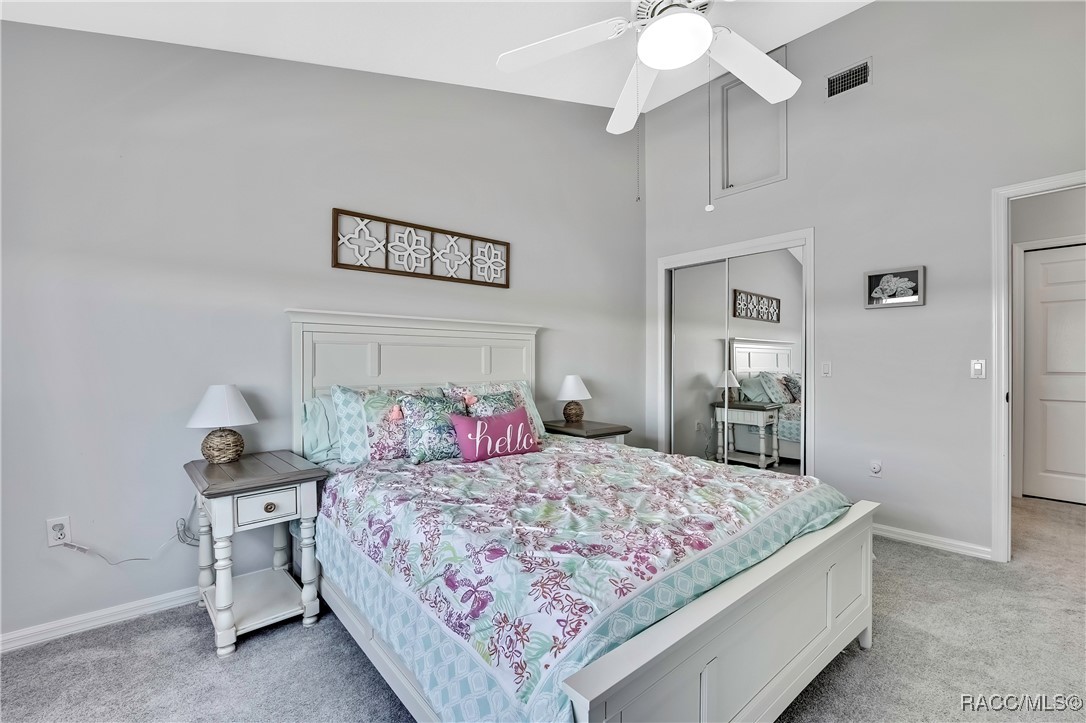 2855 North Rivers Edge Boulevard, Unit 213 Crystal River, FL 34429 - Photo 36 of 62 a bedroom with a bed and a chandelier