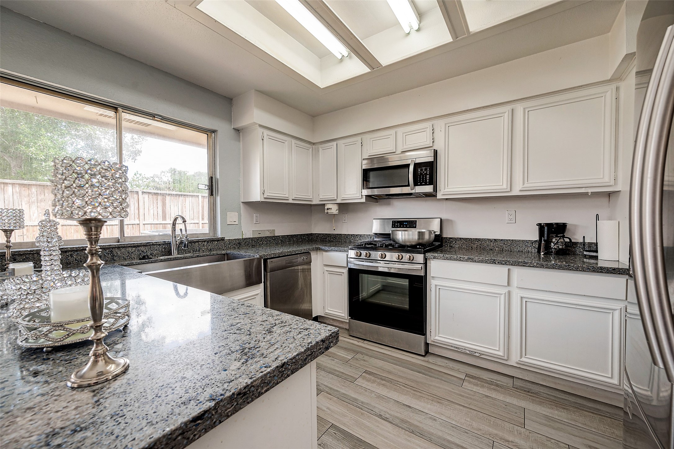 2226 Gray Hawk Lane Katy, TX 77449 - Photo 4 of 16 a kitchen with stainless steel appliances granite countertop a sink a stove and a microwave