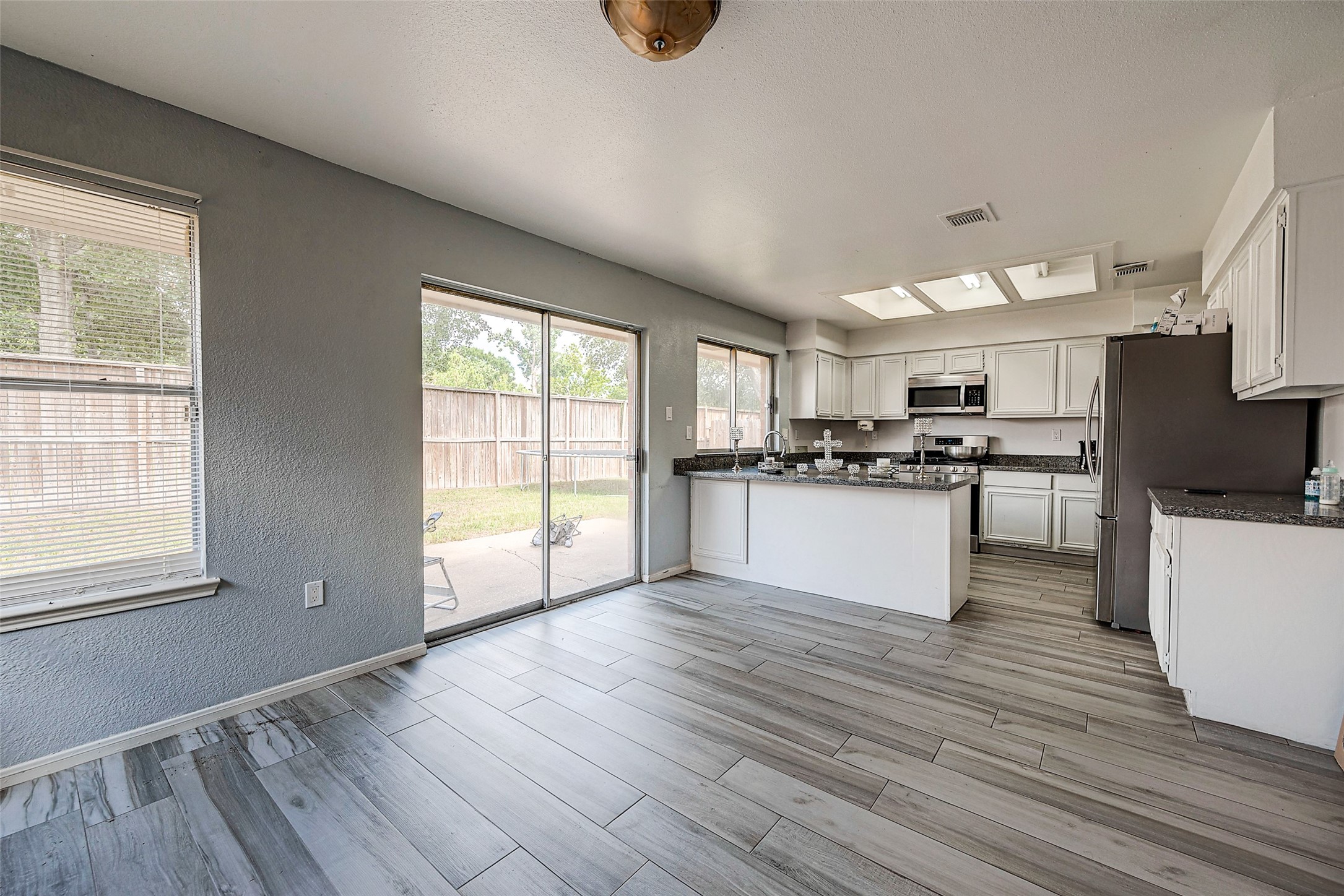 2226 Gray Hawk Lane Katy, TX 77449 - Photo 6 of 16 a kitchen with stainless steel appliances granite countertop a stove a sink and a refrigerator