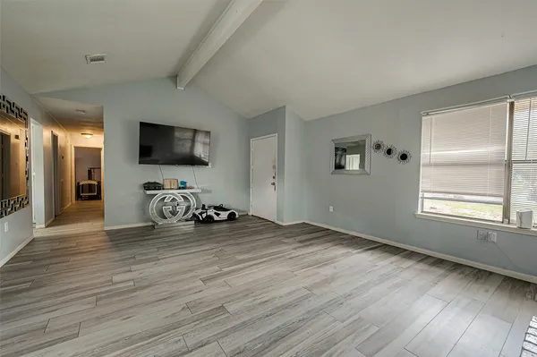 a view of a livingroom with workspace and a window