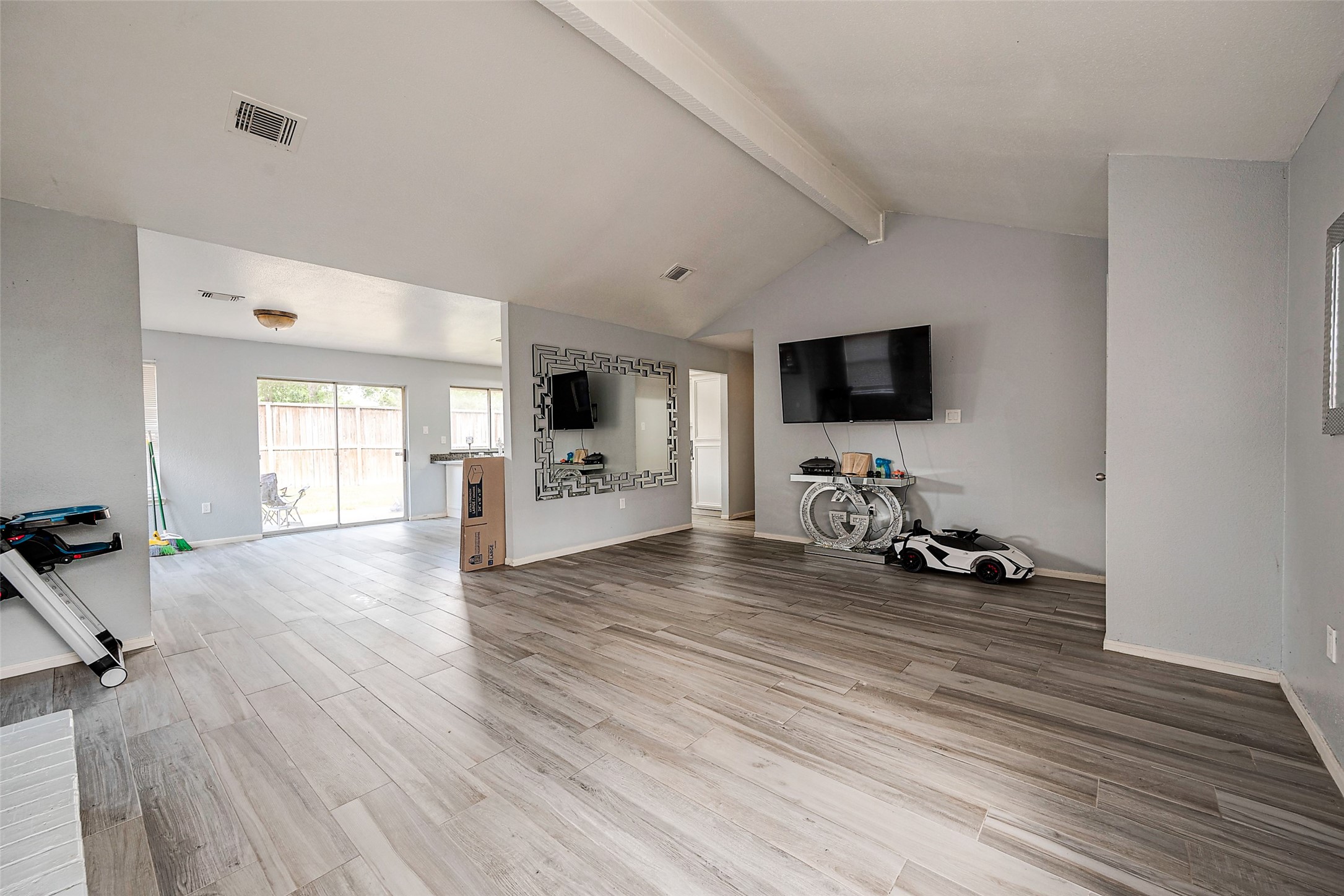 2226 Gray Hawk Lane Katy, TX 77449 - Photo 9 of 16 a view of a livingroom with a flat screen tv wooden floor and a window