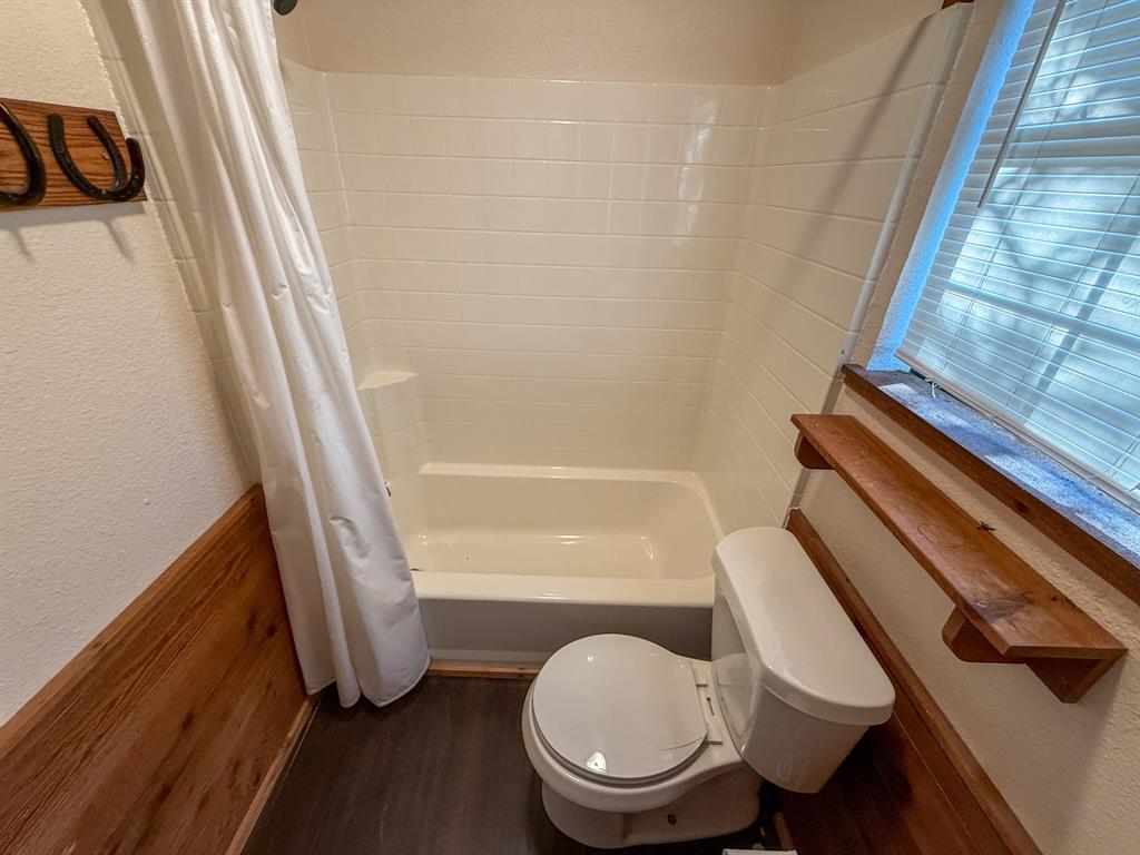 4909 Barton Chapel Road Jacksboro, TX 76458 - Photo 16 of 37 a bathroom with a toilet and a shower