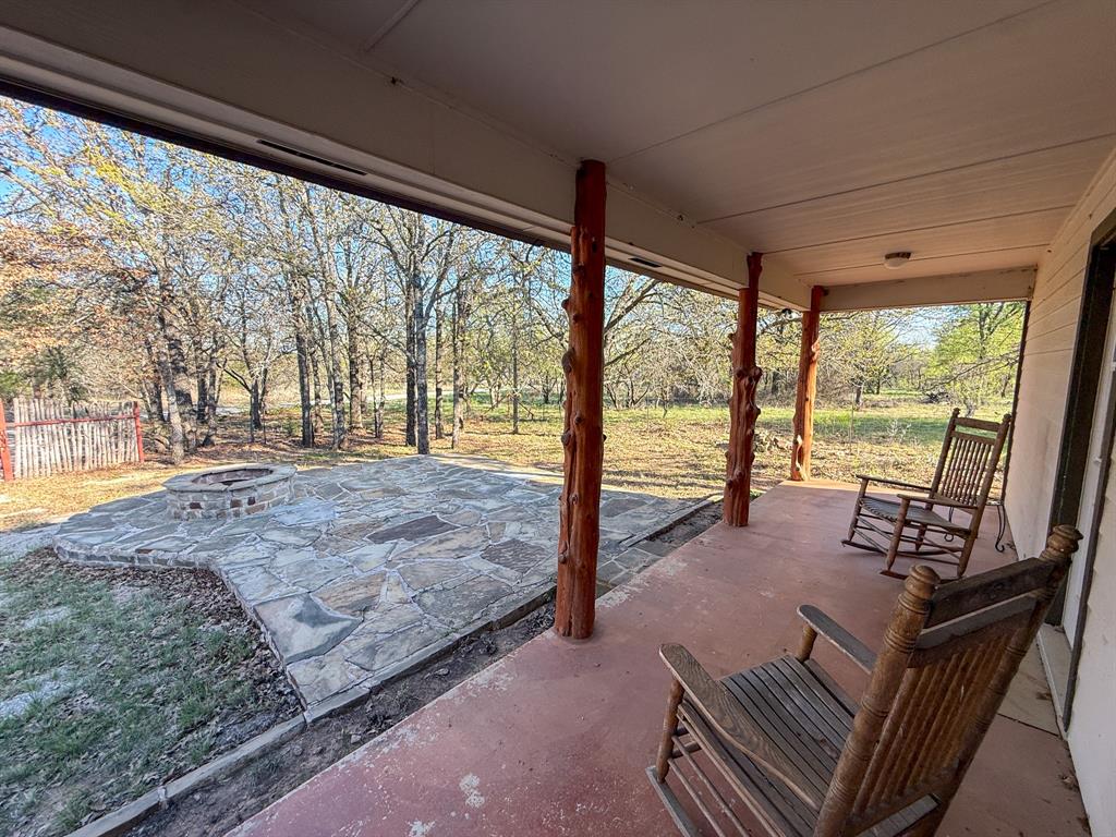 4909 Barton Chapel Road Jacksboro, TX 76458 - Photo 32 of 37 a living room with a large window and a table