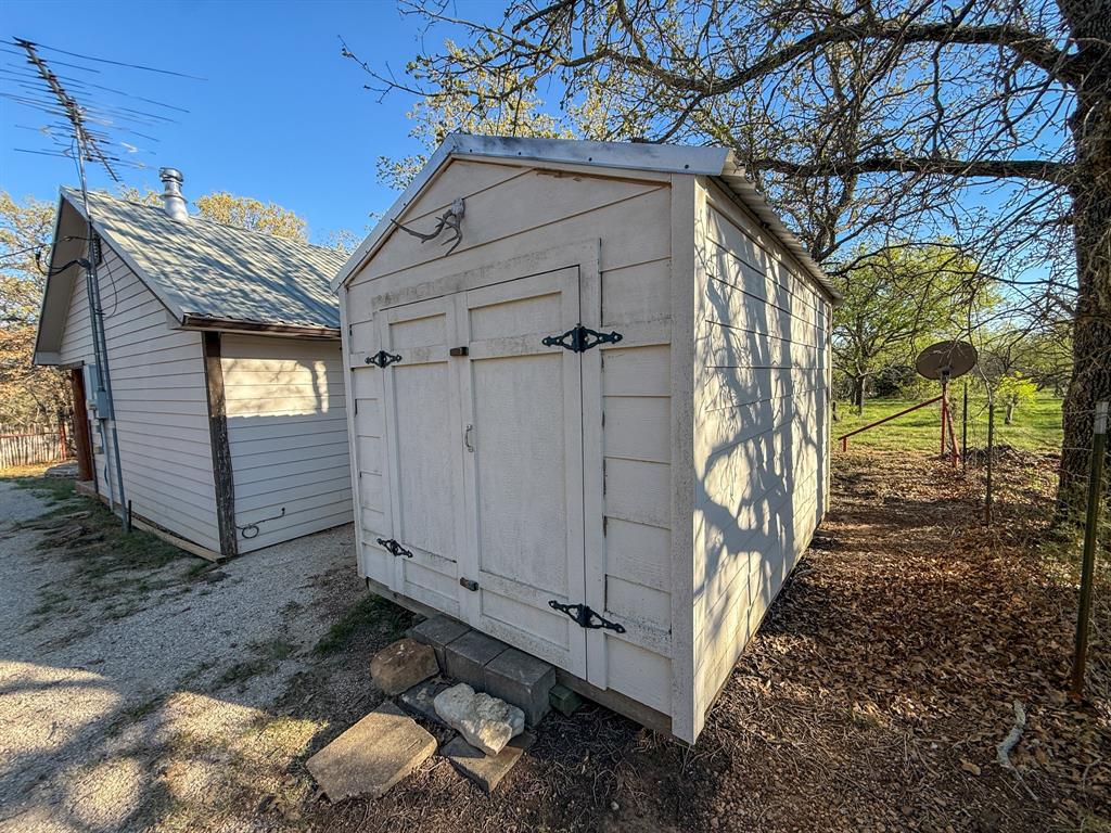 4909 Barton Chapel Road Jacksboro, TX 76458 - Photo 33 of 37 a view of a house with a small yard and wooden fence