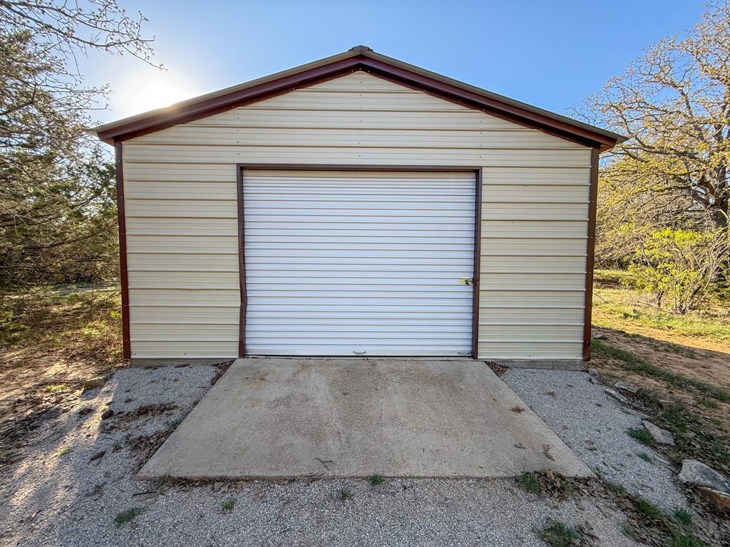 4909 Barton Chapel Road Jacksboro, TX 76458 - Photo 34 of 37 a view of a white house with a small yard and large trees