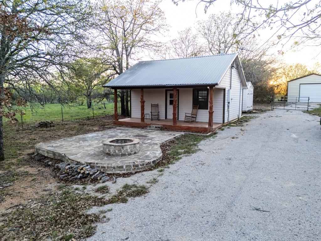 4909 Barton Chapel Road Jacksboro, TX 76458 - Photo 6 of 37 a front view of a house with a yard and garage