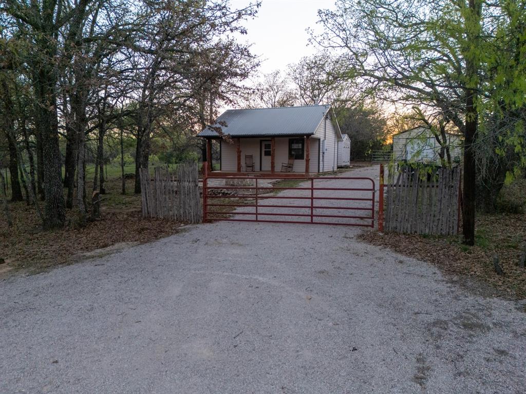4909 Barton Chapel Road Jacksboro, TX 76458 - Photo 7 of 37 a front view of a house with a garden