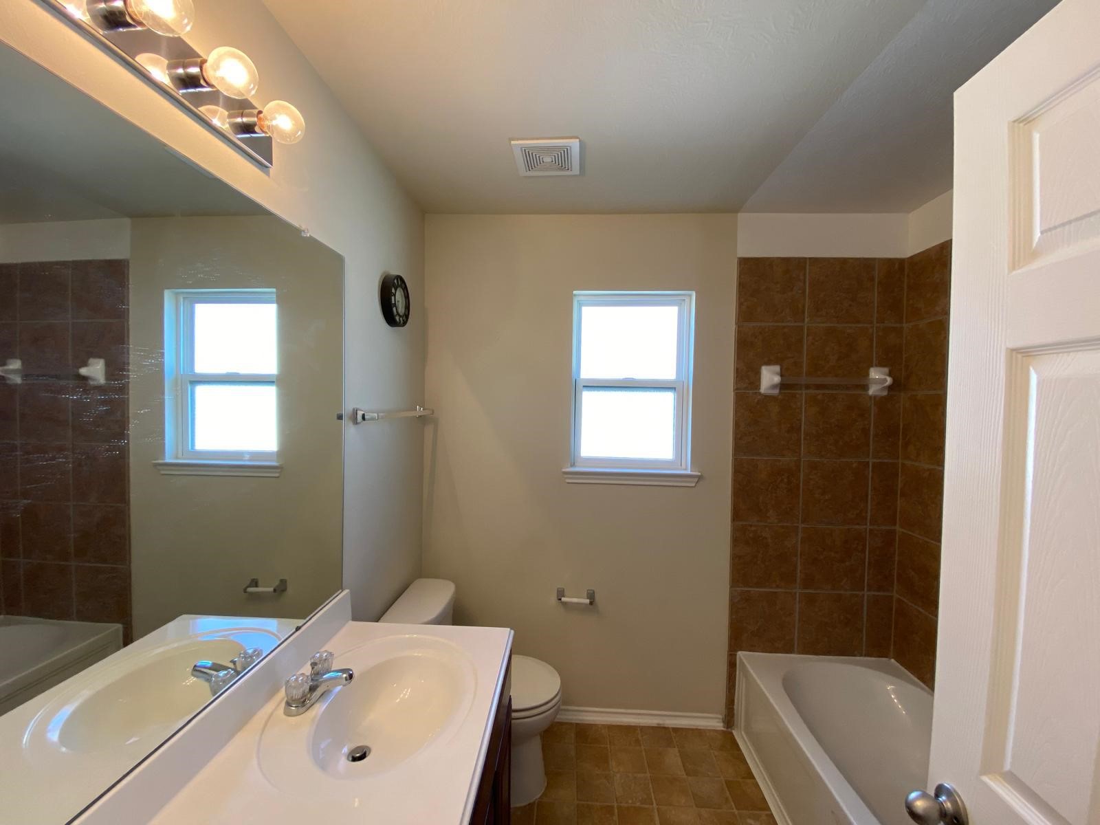 1515 Daffodil Road Missouri City, TX 77489 - Photo 11 of 20 a bathroom with a sink a toilet and shower