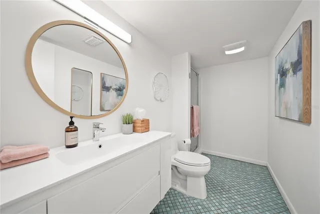 a bathroom with a toilet a sink and a mirror