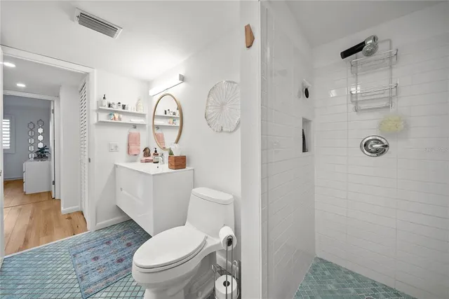 a bathroom with a toilet a sink and a mirror