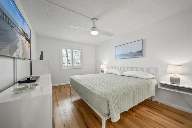 a bedroom with a bed and a night stand