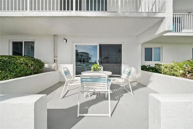 a view of a swimming pool with a patio and a yard