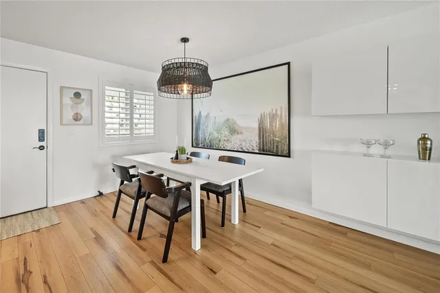 a view of a dining room with furniture wooden floor and chandelier