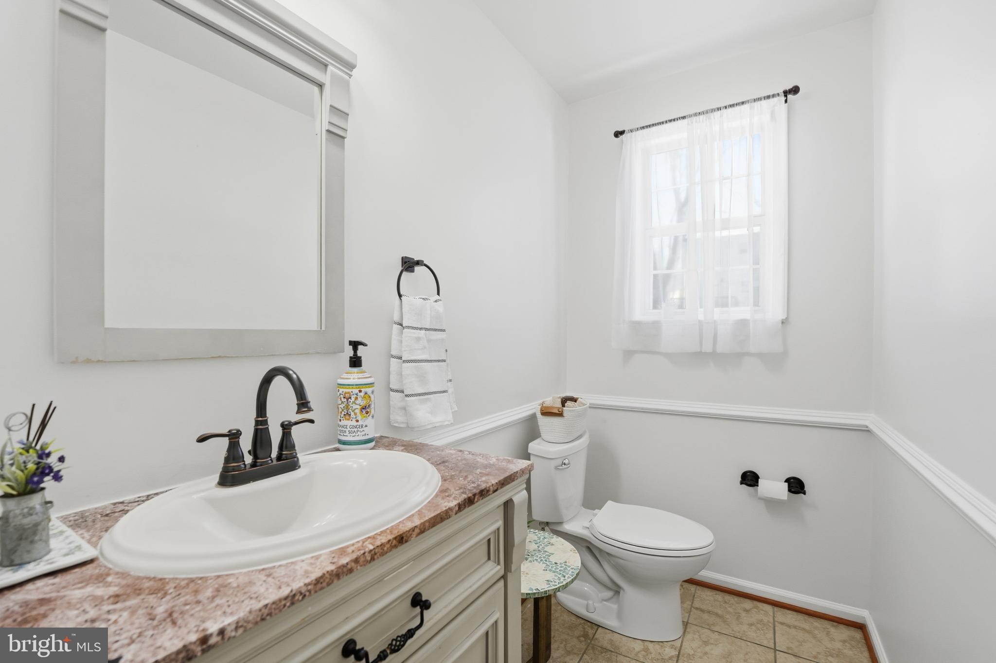 13709 Palm Road Woodbridge, VA 22193 - Photo 9 of 34 Bright and airy bathroom with elegant touches.