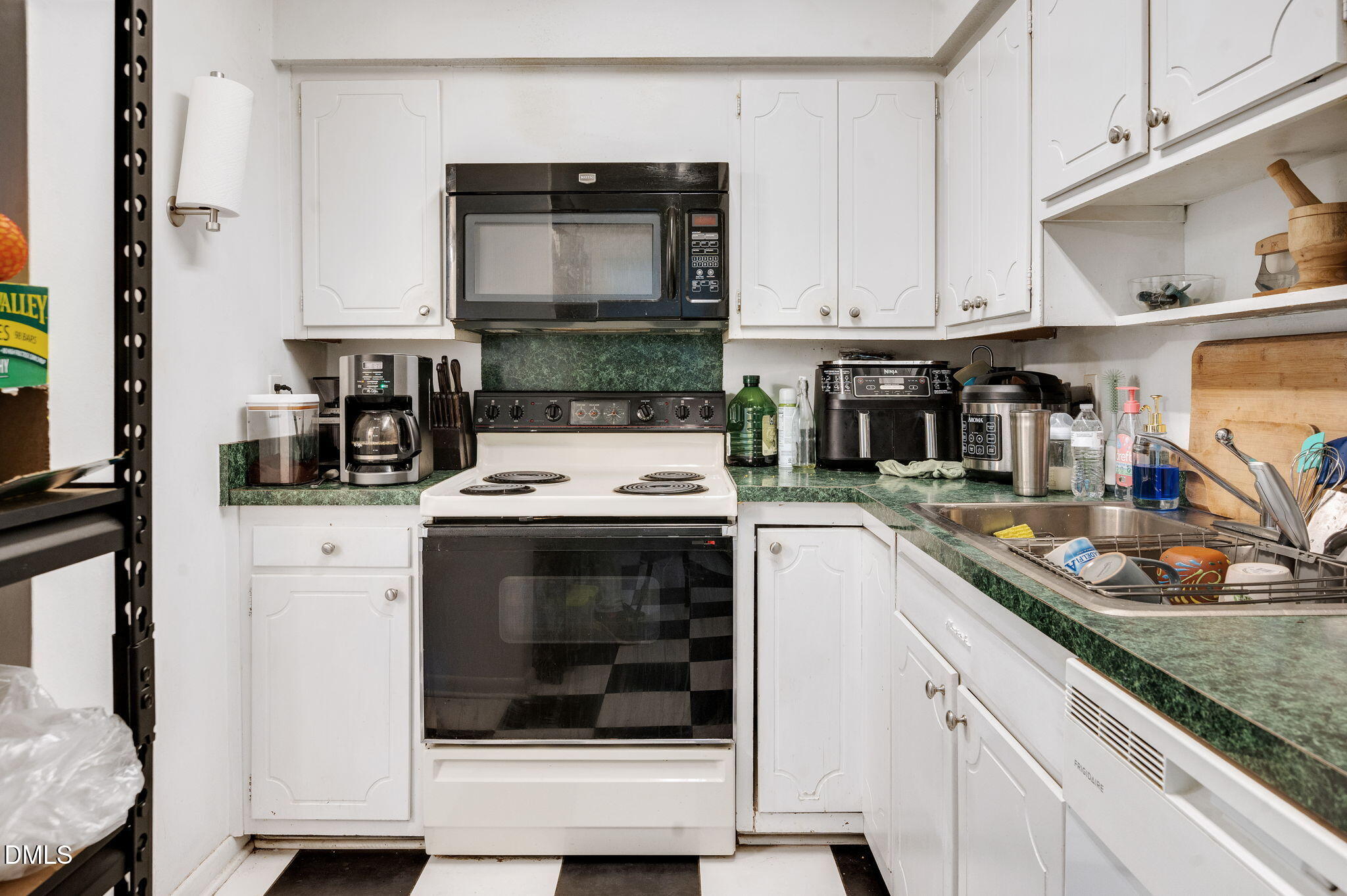 4603 Edwards Mill Road Raleigh, NC 27612 - Photo 10 of 26 a kitchen with white cabinets and appliances