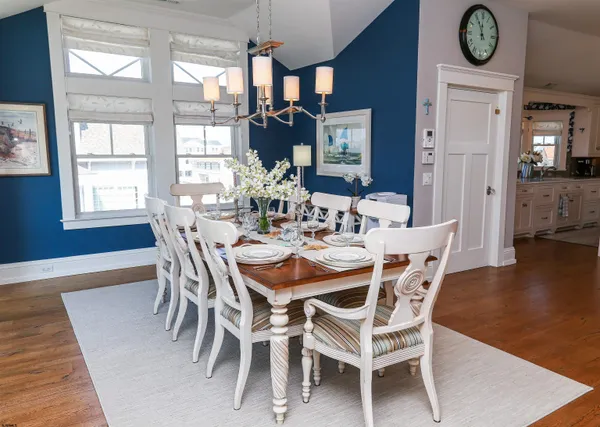 a dining room with furniture and wooden floor