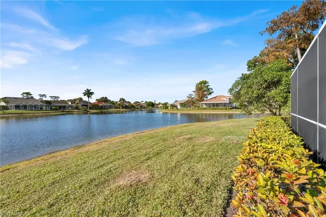 a view of a lake with houses in the back
