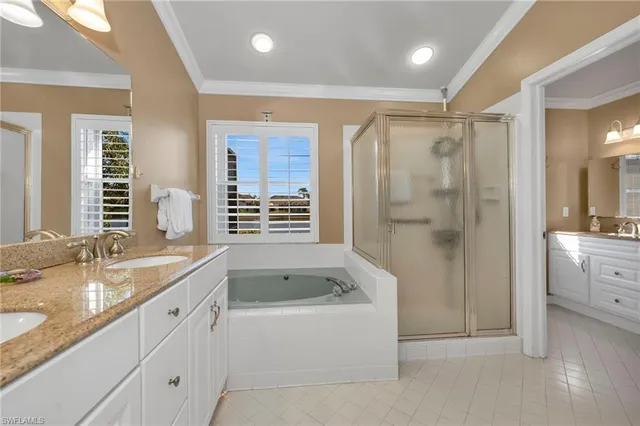 a bathroom with a granite countertop sink a bathtub a shower and a mirror