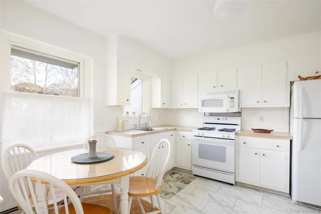 a kitchen with a stove a table and chairs
