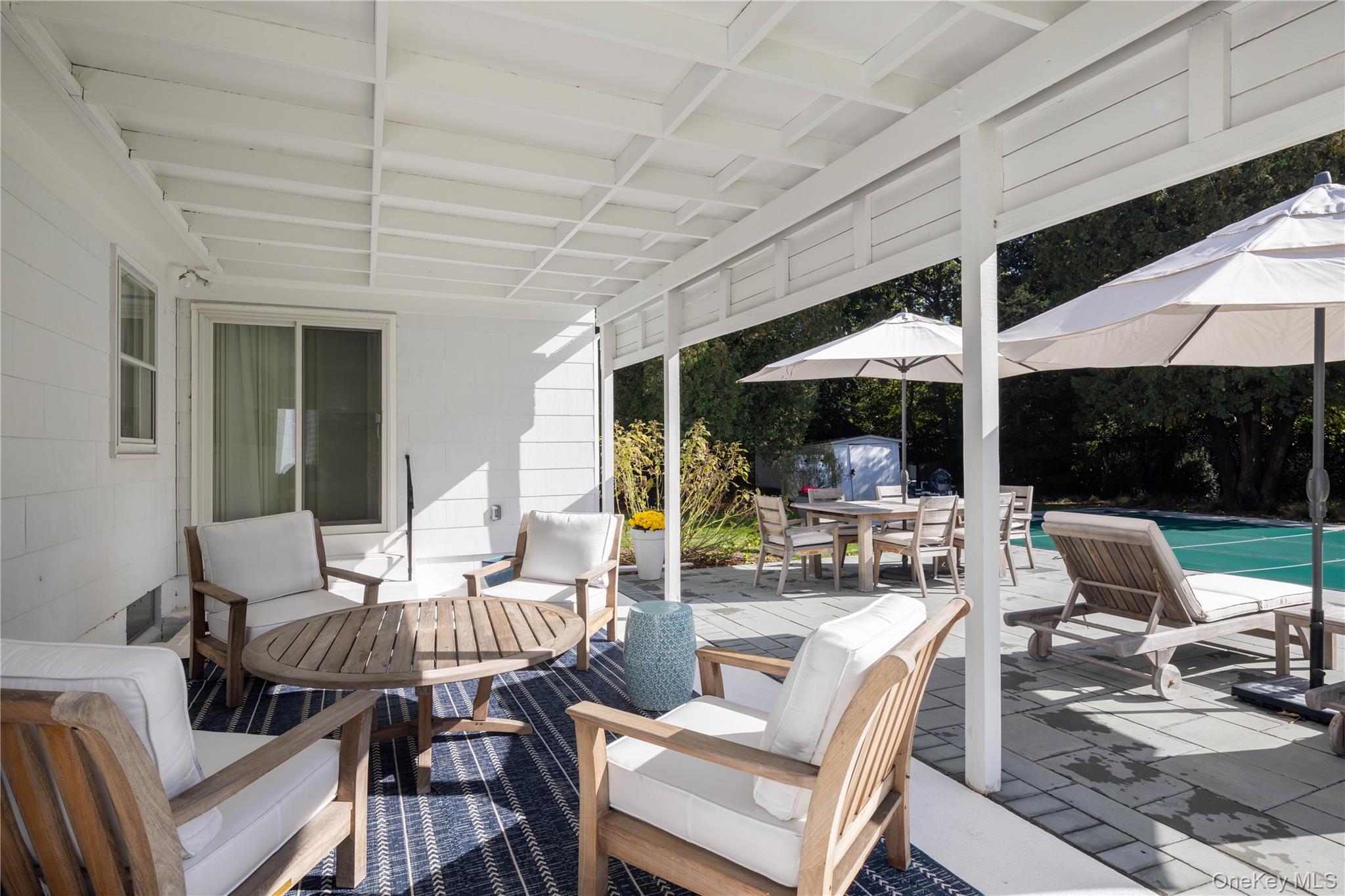 920 Pine Neck Road Southold, NY 11971 - Photo 14 of 28 a dining room with furniture water view and a fireplace