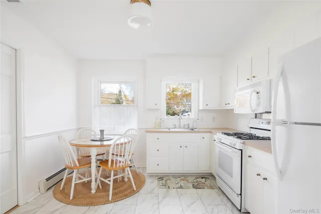 a kitchen with granite countertop a sink appliances and cabinets