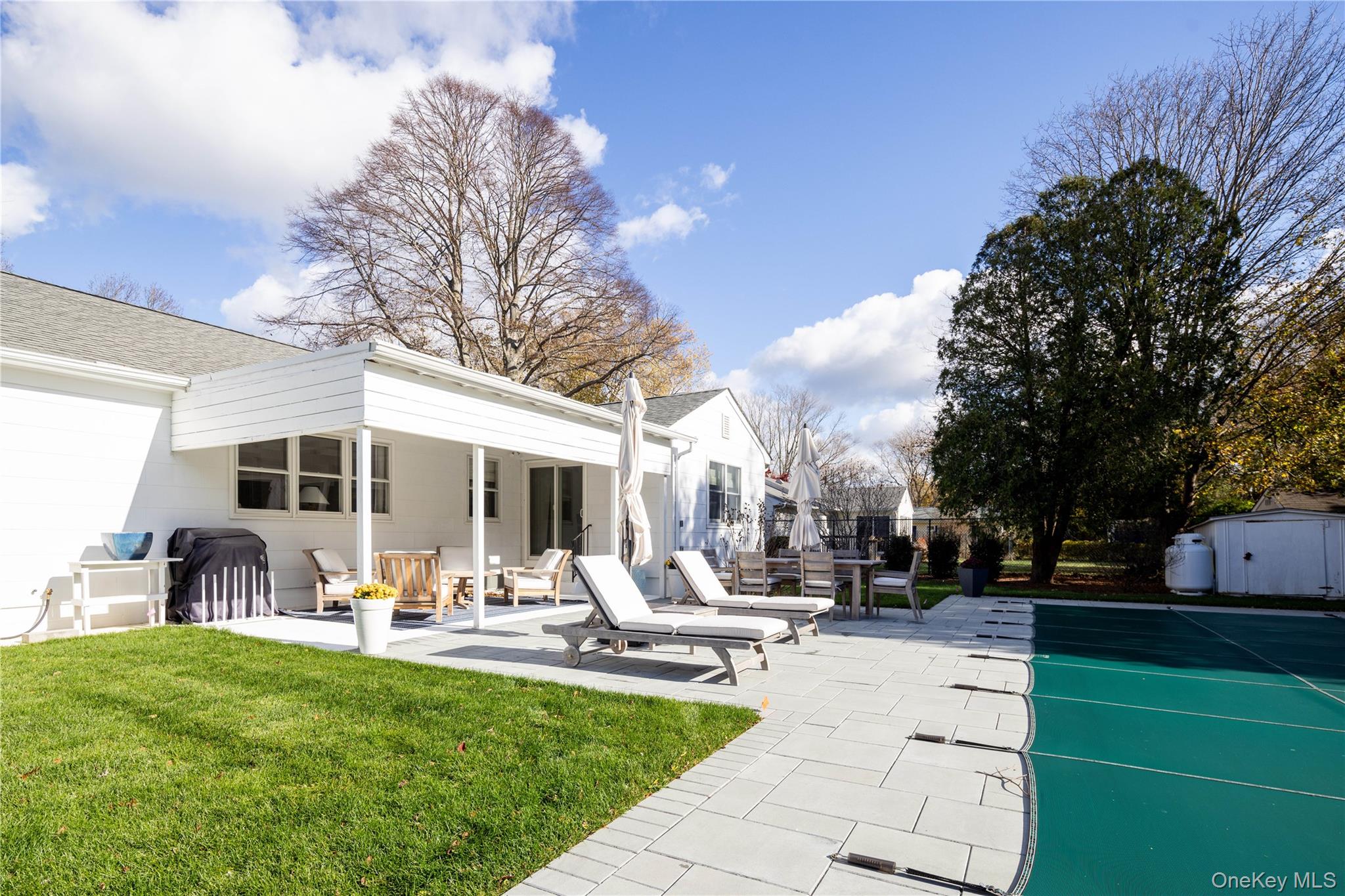 920 Pine Neck Road Southold, NY 11971 - Photo 16 of 28 a view of a backyard with sitting area