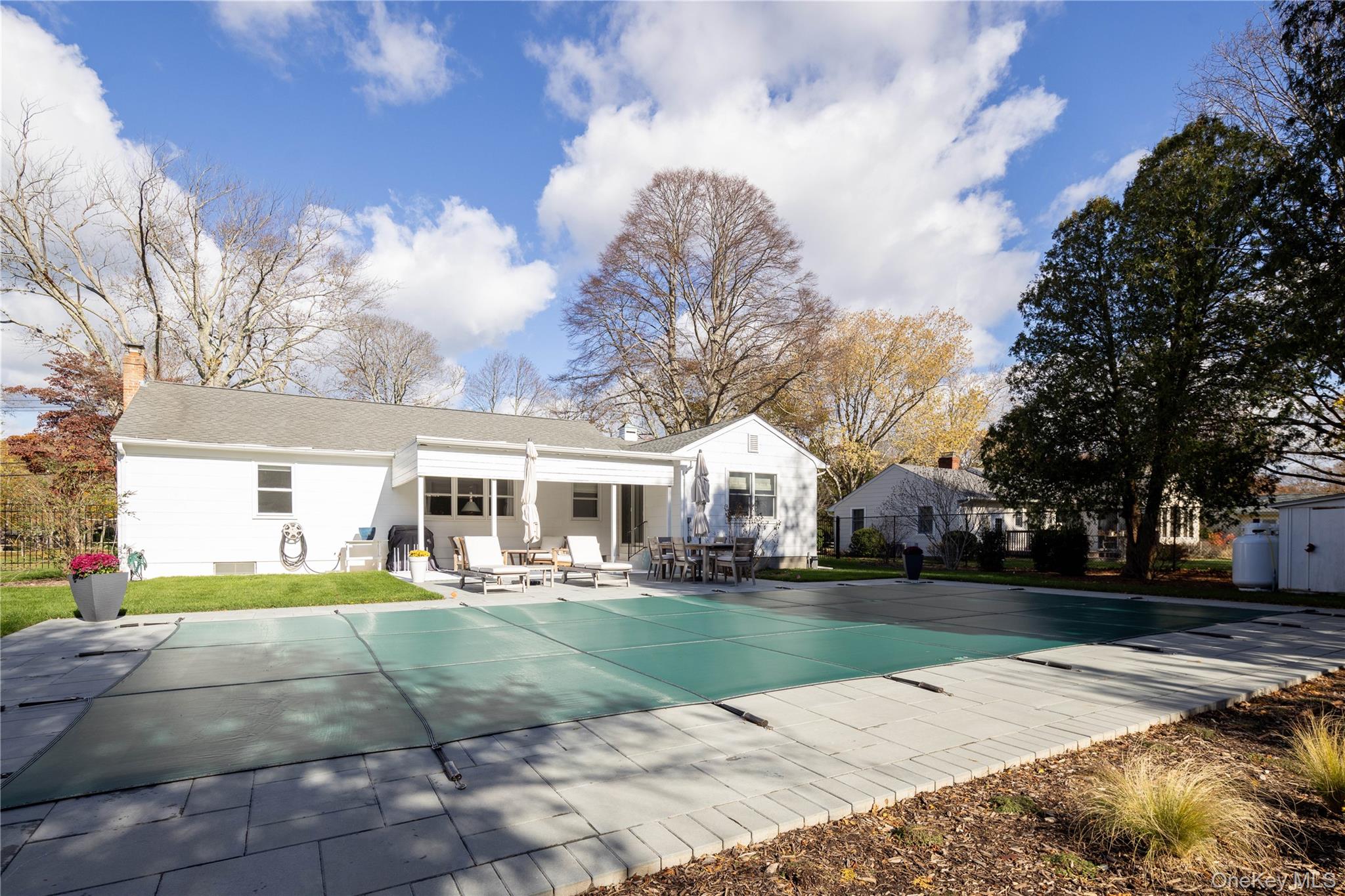 920 Pine Neck Road Southold, NY 11971 - Photo 17 of 28 a view of a white house with a big yard and large trees