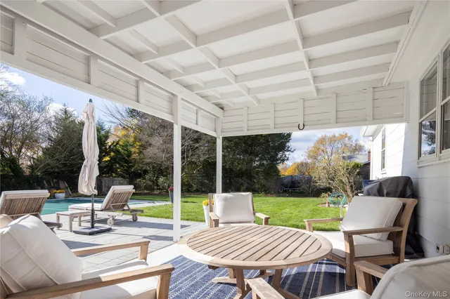 a view of a patio with a dining table and chairs with a patio